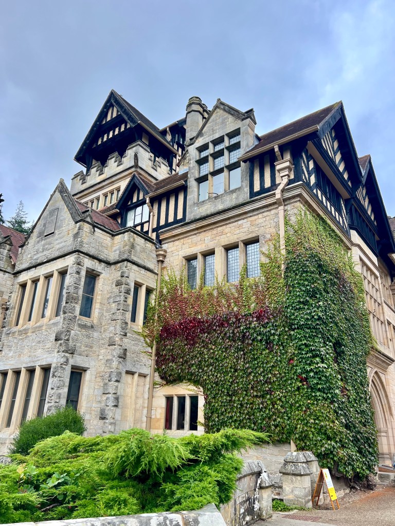 A photo of the outside of Cragside House with various gables and windows in different architecture styles. 