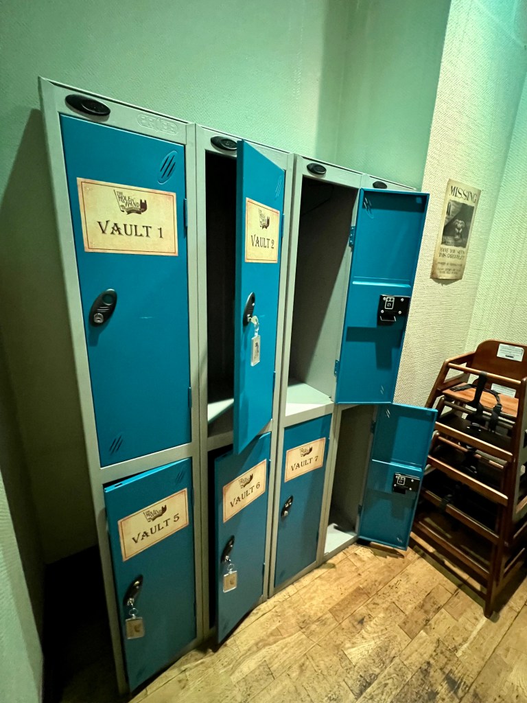 The photo shows a set of 8 large blue lockers with the doors partially opened. 