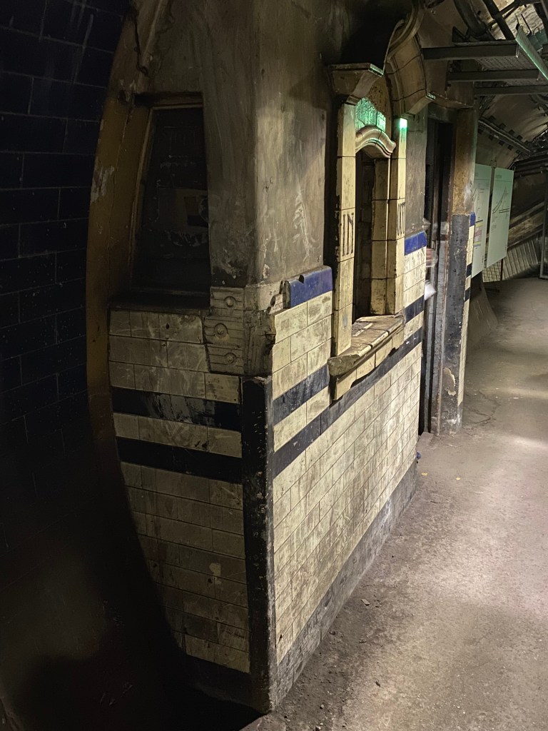 Part of the disused tunnel and the window of the small ticket office.