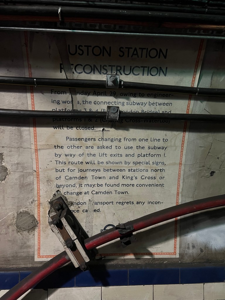 A poster of the wall of the tunnel, new wires have been attached to the wall on top of the poster.