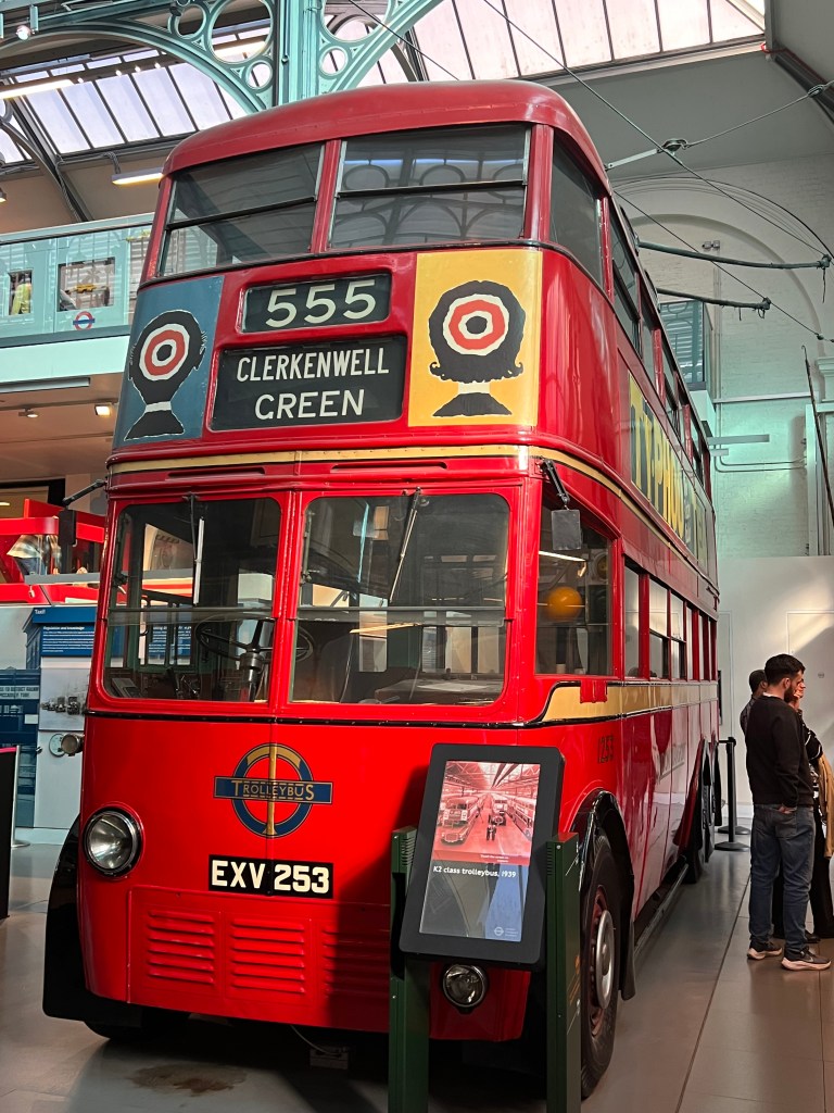 An old double decker red bus, with the number 555 displayed and the destination Clerkenwell Green. 