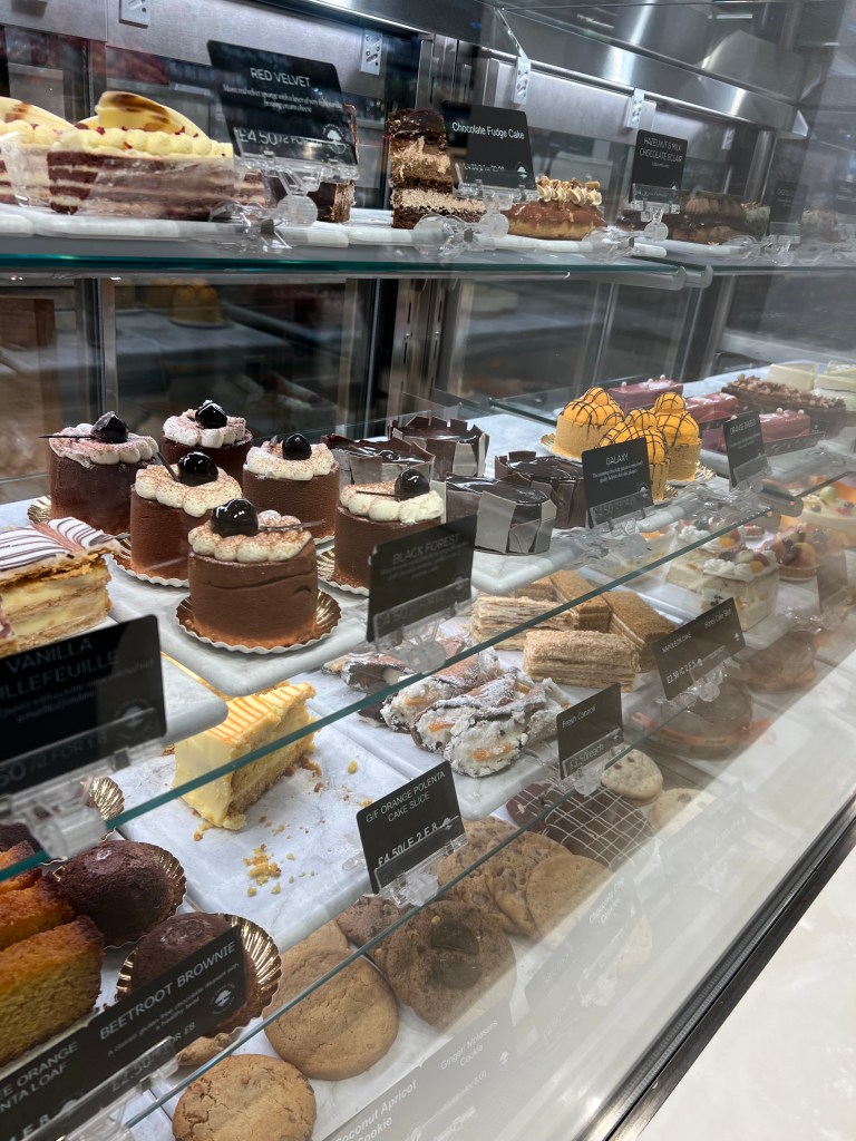The cake cabinet at Kavanagh's with a selection of individual cakes and cake slices. 
