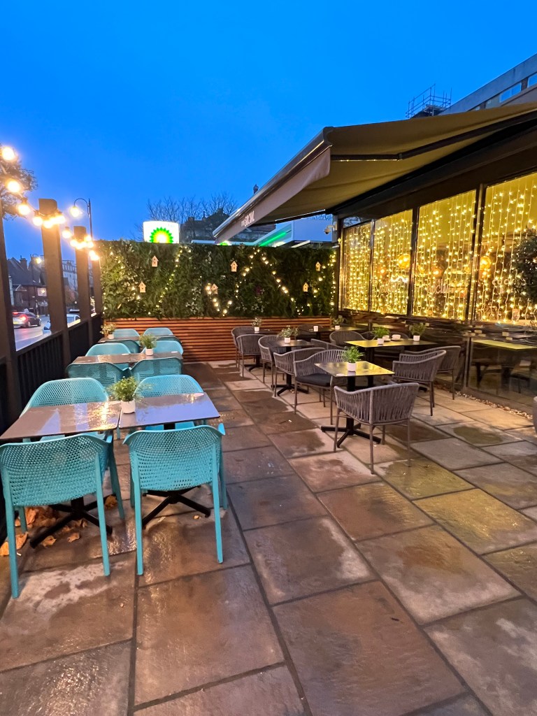 The outside seating area with tables and chairs. 