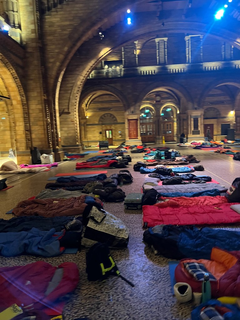 An image of Hintze Hall with sleeping bags laid out on the floor.