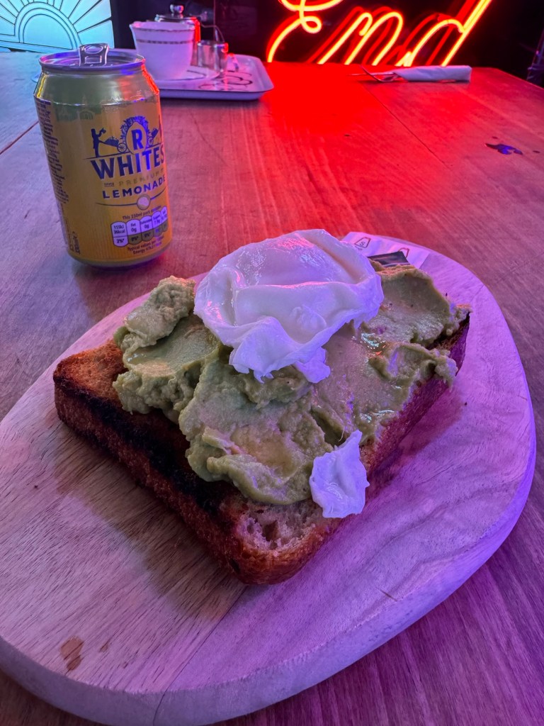 Avocado and a poached egg on toast with a can of R. White's lemonade. 